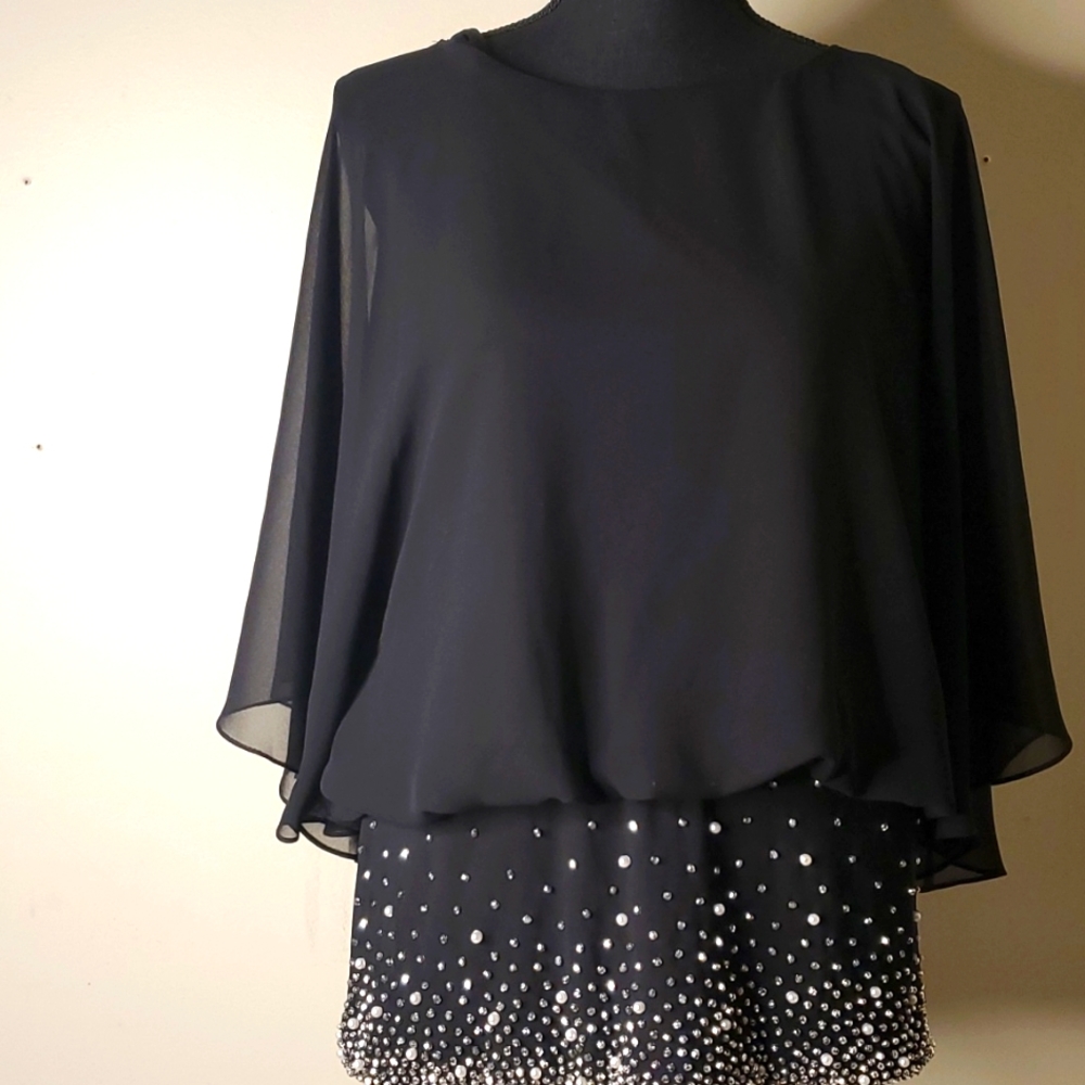 Black sheer chiffon studded blouse with a  fitted waist flutter sleeves.